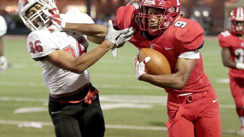 Fairfield’s JuTahn McClain (9) stiff-arms Colerain’s Deshawn Pace on a run during a game at Fairfield Stadium on Oct. 13, 2017. CONTRIBUTED PHOTO BY TONY TRIBBLE/WCPO.COM