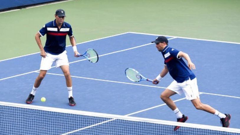 Mike Bryan, left, was fined $10,000 at the U.S. Open after making a shooting gesture with his tennis racket during Saturday night's match. Bryan and his brother, Bob, won their match at the tournament early Sunday.