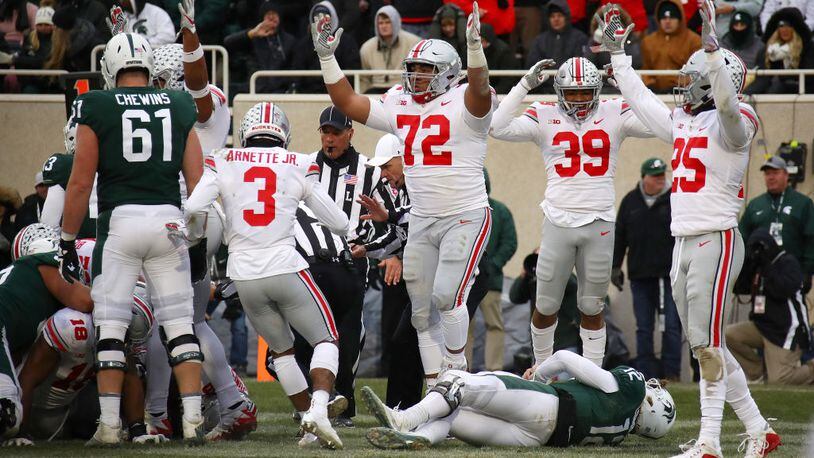 EAST LANSING, MI - NOVEMBER 10: Rocky Lombardi #12 of the Michigan State Spartans lays on the ground as the Ohio State Buckeyes celebrate a fourth quarter fumble recovery for a touchdown at Spartan Stadium on November 10, 2018 in East Lansing, Michigan. (Photo by Gregory Shamus/Getty Images)