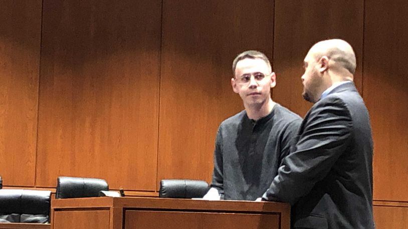 Samuel Ronan discusses terms of his sentence on Thursday with lawyer James Calhoun in Warren County Common Pleas Court. STAFF/LAWRENCE BUDD