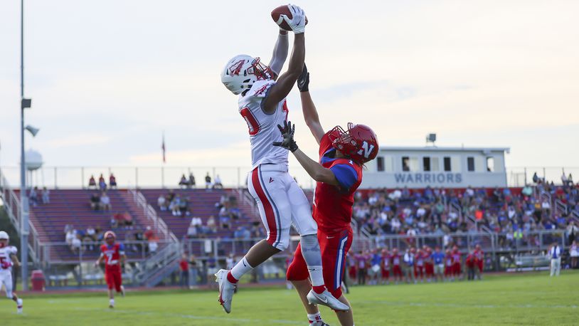 Stebbins High School junior Adrian Norton leaps over Northwestern's Austin Ernst to catch a touchdown pass during their game on Thursday, Aug. 19 at Taylor Field in Springfield. The Indians won 55-14. CONTRIBUTED PHOTO BY MICHAEL COOPER