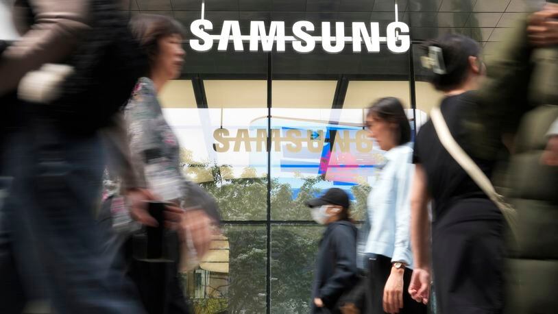 People pass by a Samsung Gangnam store in Seoul, South Korea, Tuesday, April 30, 2024. Samsung Electronics on Tuesday reported a 10-fold increase in operating profit for the last quarter as the expansion of artificial intelligence technologies drives a rebound in the markets for computer memory chips. (AP Photo/Ahn Young-joon)