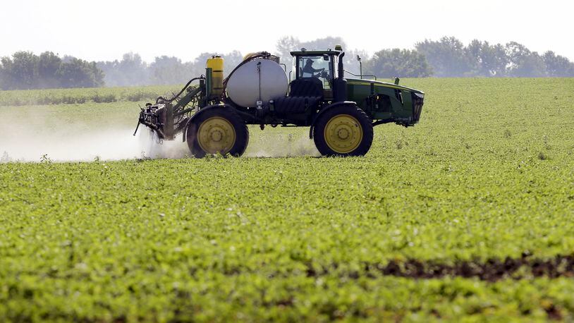 FILE - A soybean field is sprayed in Iowa, July 11, 2013. The maker of a popular weedkiller is turning to lawmakers in key states to try to squelch legal claims that it failed to warn about cancer risks. (AP Photo/Charlie Neibergall, File)