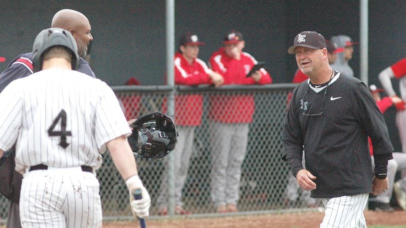 Lakota East coach Ray Hamilton talks with the home-plate umpire Saturday during the Thunderhawks’ 5-3, nine-inning loss to visiting Lakota West in Greater Miami Conference baseball action. RICK CASSANO/STAFF
