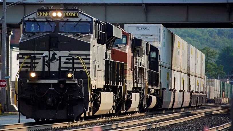 FILE - A Norfolk Southern freight train runs through a crossing on Sept. 14, 2022, in Homestead, Pa. Norfolk Southern reports earnings on Wednesday, April 24, 2024. (AP Photo/Gene J. Puskar, File)