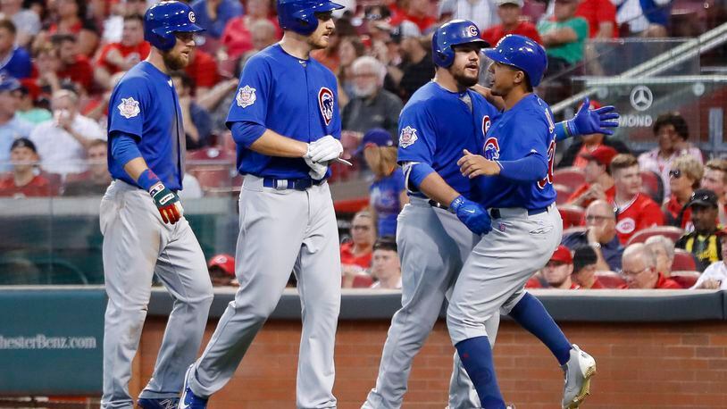 Chicago Cubs’ Kyle Schwarber, center right, celebrates with Jon Jay, right, Mike Montgomery, center left, and Ben Zobrist after hitting a three-run home run off Cincinnati Reds starting pitcher Asher Wojciechowski during the fourth inning of a baseball game, Wednesday, Aug. 23, 2017, in Cincinnati. (AP Photo/John Minchillo)