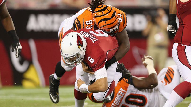GLENDALE, AZ - AUGUST 24: Quarterback Logan Thomas #6 of the Arizona Cardinals is sacked by defensive end Will Clarke #93 of the Cincinnati Bengals during the fourth quarter of the preseason NFL game at the University of Phoenix Stadium on August 24, 2014 in Glendale, Arizona. (Photo by Christian Petersen/Getty Images)
