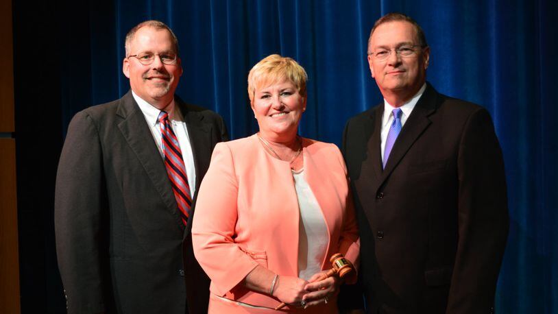 Talawanda Superintendent Kelly Spivey (middle) holds the gavel marking her installation as president of the Buckeye Association of School Administrators in August 2016. She is pictured with Talawanda school board vice president Michael Crowder (left) and Talawanda High School principal Tom York. CONTRIBUTED/BOB RATTERMAN