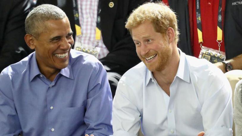 Former President Barack Obama, left, and Prince Harry share a joke during the Invictus Games in September.