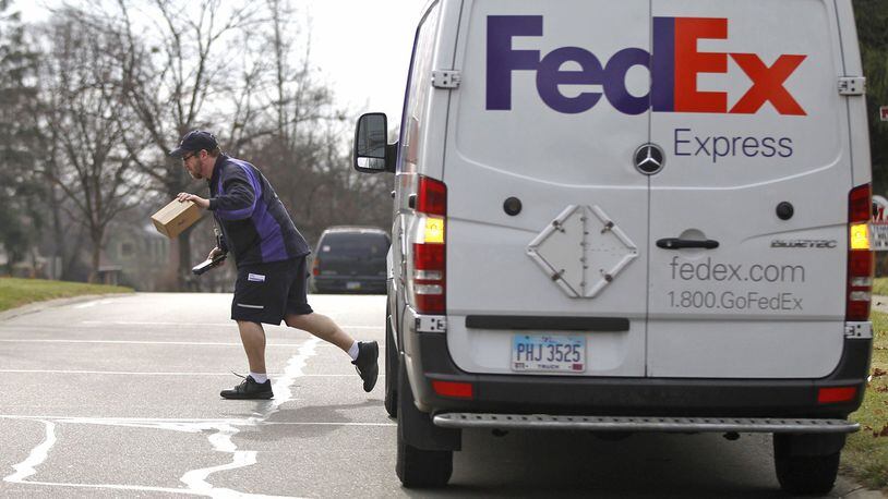 FedEx driver, UPS and USPS expect to deliver record numbers of packages this holiday season. TY GREENLEES / STAFF