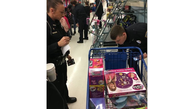 Middletown Police Department employees took 61 children shopping Saturday at the Meijer store on Towne Boulevard to pick out gifts worth up to $100 per child. The event was part of the department’s Mike Davis Christmas with a Cop program. MIKE RUTLEDGE/STAFF