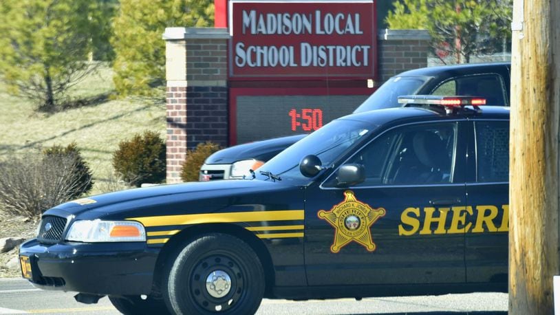 The Ohio Supreme Court heard the case about the Madison Local Schools armed staff policy on Jan. 12, 2021. Butler County sheriffs deputies block the entrance to Madison Jr./Sr. High School after a shooting in 2016. STAFF FILE/2016
