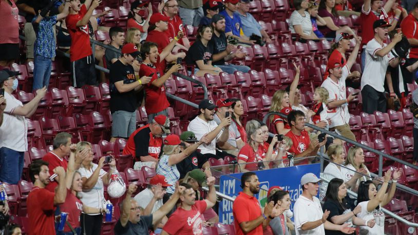 Reds fans cheer after the final out of a victory against the Brewers on Friday, May 21, 2021, at Great American Ball Park in Cincinnati. David Jablonski/Staff