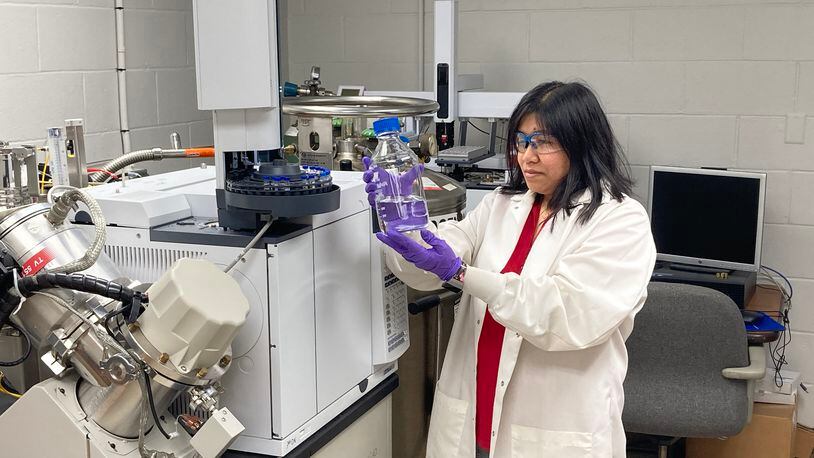 University of Dayton Research Institute fuels and combustion researcher Jhoanna Alger examines a jet fuel sample.