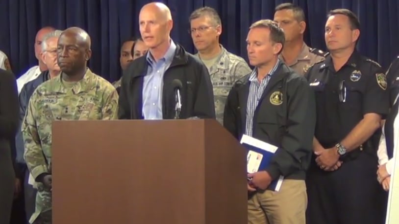 Florida Governor Rick Scott, alongside Jacksonville's mayor and emergency management officials, at a briefing in Jacksonville for Hurricane Matthew