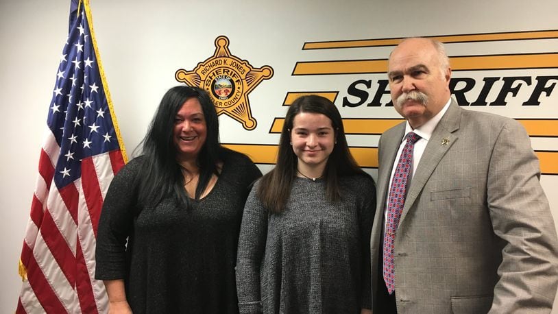 Patty Scott (left) poses with her daughter, Erika Scott, (center) and Butler County Sheriff Richard K. Jones at a press conference held Thursday morning. Erika discussed concerns regarding school safety in light of the recent incident in Parkland, Florida.