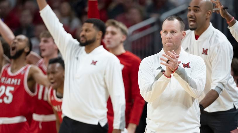 Miami (Ohio) head coach Travis Steele, front right, reacts during the first half of an NCAA college basketball game against Indiana, Sunday, Nov. 20, 2022, in Indianapolis. (AP Photo/Marc Lebryk)