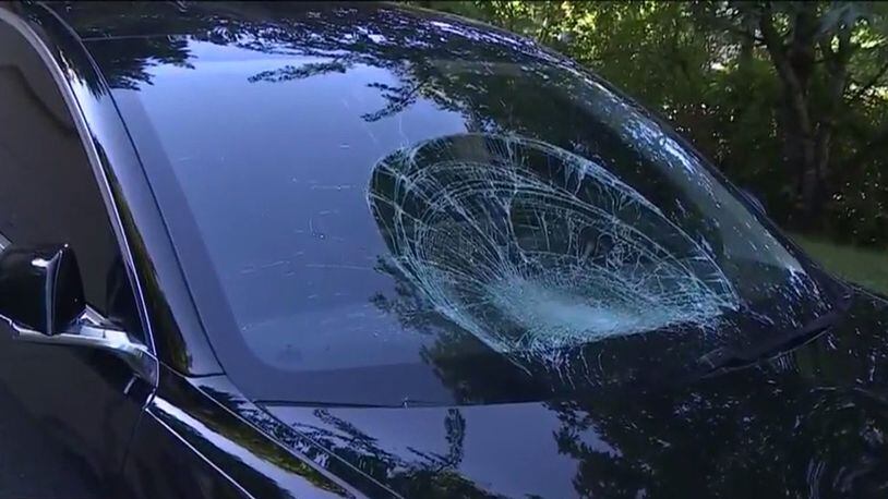 Police said the man jumped onto a black Tesla Model 3. The driver told officers the man jumped on the hood of his car and caused visible dents. (KIRO7.com)