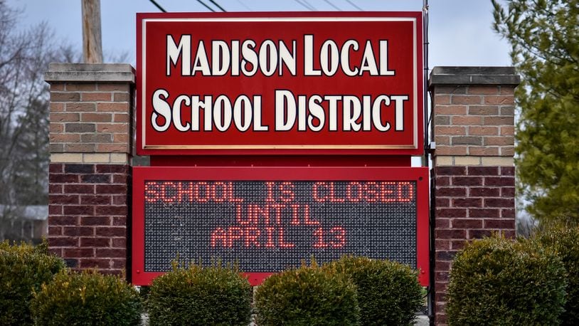The sign at Madison Local School District displays school is closed until April 13 on it Tuesday, March 17, 2020. The Governor of Ohio ordered all schools to be closed for three weeks to help reduce the spread of coronavirus. NICK GRAHAM / STAFF