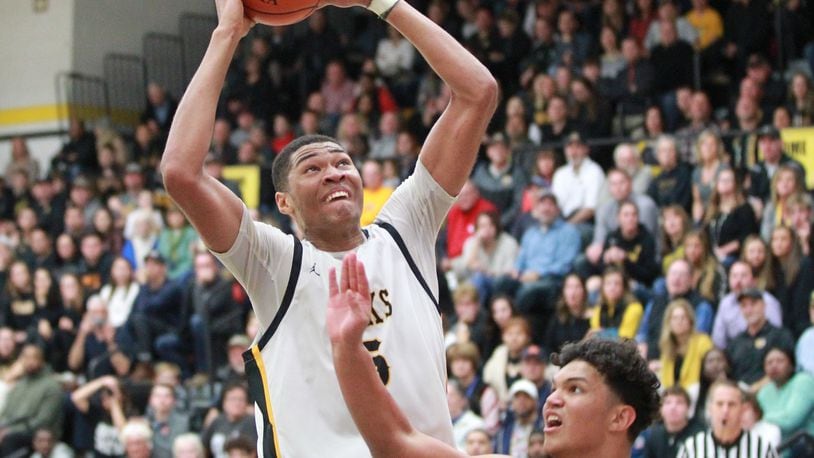Mo Njie of Centerville elivates over Elijah Brown of Wayne. Wayne defeated host Centerville 52-50 in a GWOC boys high school basketball game on Friday, Dec. 13, 2019. MARC PENDLETON / STAFF
