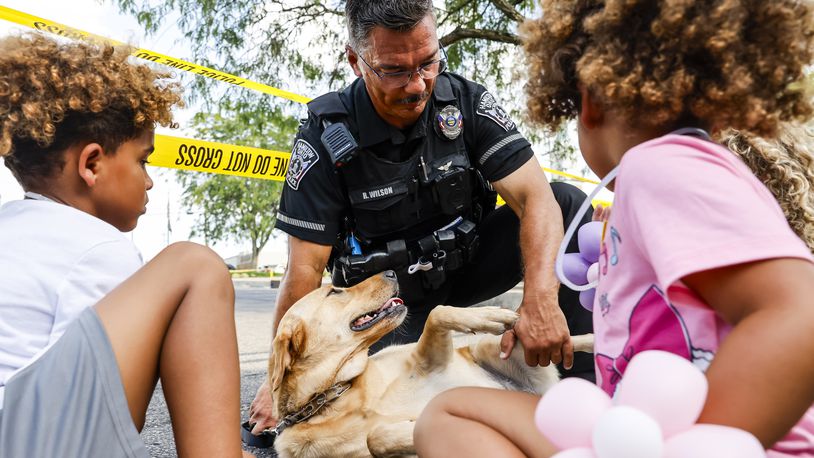 Hamilton Police Officer Rodney Wilson shows off his new therapy dog, Gloria, during an open house for Hamilton Police Department Thursday, Aug. 3, 2023. NICK GRAHAM/STAFF