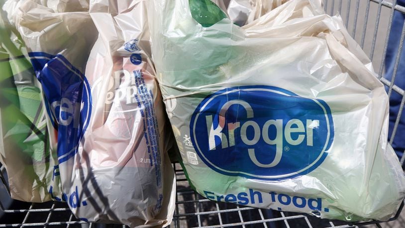 In this June 15, 2017, photo, bagged purchases from the Kroger grocery store in Flowood, Miss., sit inside this shopping cart. Kroger reports financial results on Wednesday, March 7, 2018. (AP Photo/Rogelio V. Solis)