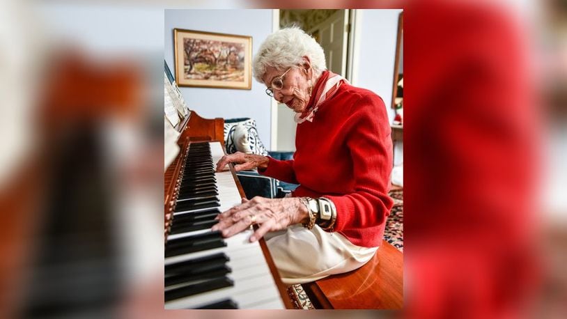 Margaret Lewis plays piano in her home Tuesday, Nov. 28, 2017 in Hamilton. Lewis turned 100-years-old on Dec. 17, 2017. Community First Solutions is celebrating its 100th birthday this year and plans to hand-deliver free birthday cakes to centenarians.