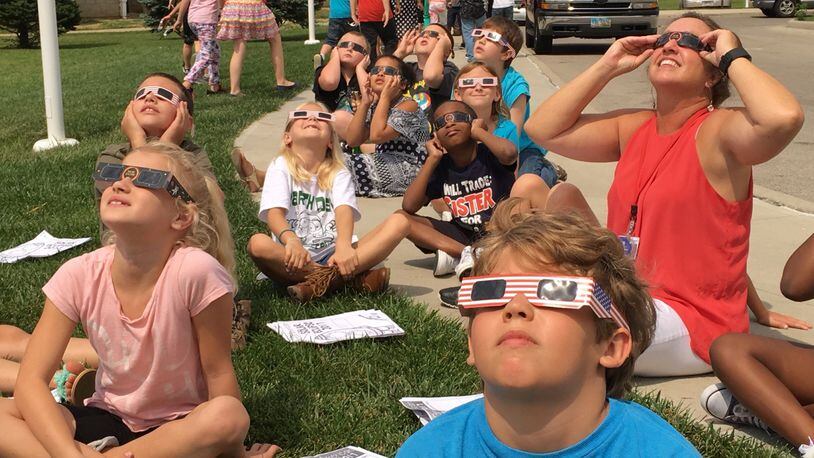 Horace Mann Elementary School students and teachers watch the solar eclipse at the Springfield school. Bill Lackey/Staff