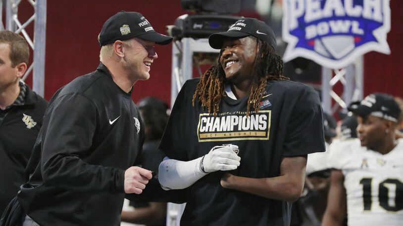 ATLANTA, GA - JANUARY 01:  Head coach Scott Frost of the UCF Knights celebrates with Shaquem Griffin #18 after defeating the Auburn Tigers 34-27 to win the Chick-fil-A Peach Bowl at Mercedes-Benz Stadium on January 1, 2018 in Atlanta, Georgia.  (Photo by Streeter Lecka/Getty Images)