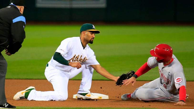 OAKLAND, CALIFORNIA - MAY 08: Marcus Semien #10 of the Oakland Athletics tags out Jose Peraza #9 of the Cincinnati Reds during the fourth inning at Oakland-Alameda County Coliseum on May 08, 2019 in Oakland, California. (Photo by Daniel Shirey/Getty Images)