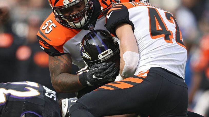 Running back Gus Edwards of the Baltimore Ravens is tackled by outside linebacker Vontaze Burfict of the Cincinnati Bengals during the first half at M&T Bank Stadium on November 18, 2018 in Baltimore, Maryland. (Photo by Patrick Smith/Getty Images)