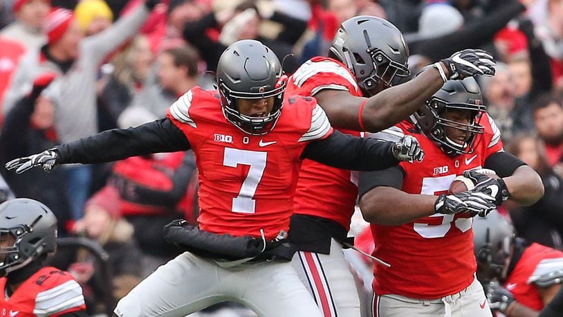 Ohio State Buckeyes defensive tackle Davon Hamilton (53) is congratulated by safety Damon Webb (7) and defensive end Jalyn Holmes (center) following his fumble recovery at the goal line during the third quarter.
