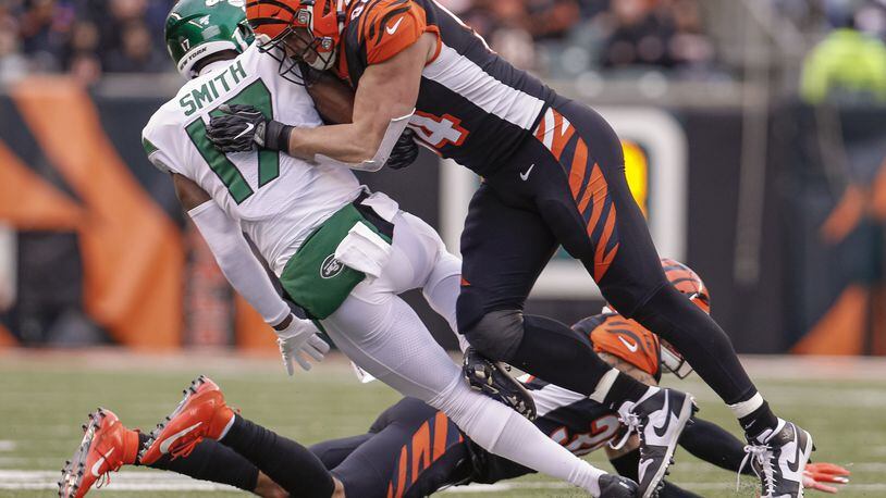 CINCINNATI, OH - DECEMBER 01: Sam Hubbard #94 of the Cincinnati Bengals makes the hit on Vyncint Smith #17 of the New York Jets during the first half at Paul Brown Stadium on December 1, 2019 in Cincinnati, Ohio. (Photo by Michael Hickey/Getty Images)