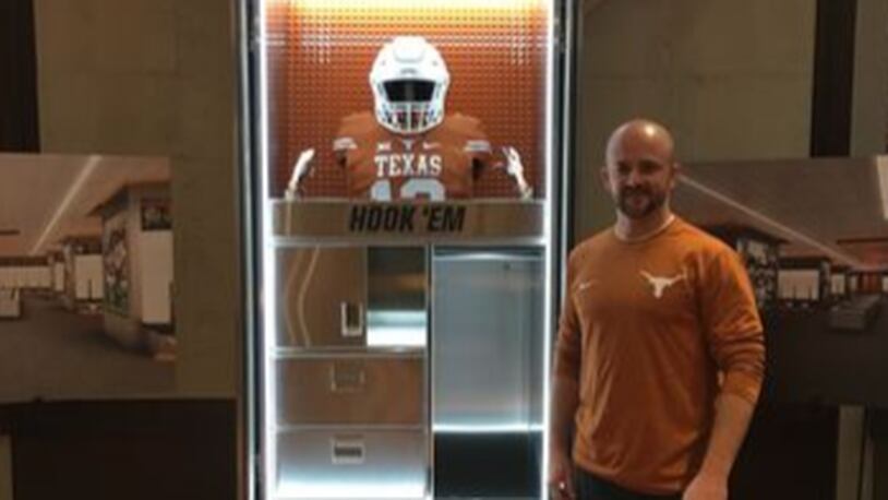 Sam Allen, whose Longhorn Lockers custom lockers company built the University of Texas’ new lockers, stands next to one of his creations. (Photo: Courtesy Sam Allen)