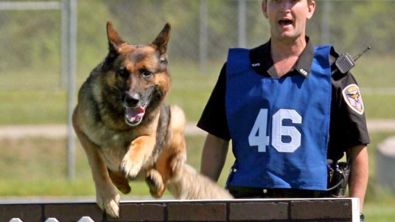 In this 2008 file photo are Oxford police officer Shawn Terrell and Oxford police K9 Simon. A new police K9 unit is coming to Oxford to primarily be used for drug detection work. GREG LYNCH/STAFF