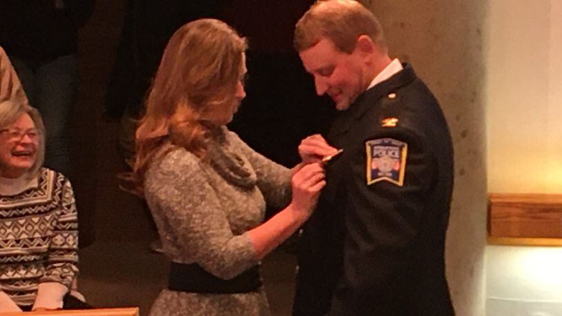 New Middletown police Chief David Birk is pinned with his new badge by his wife Kila during the Jan. 7 meeting of Middletown City Council. The pinning ceremony was witnessed by most of the members of the Division of Police. Acting City Manager Susan Cohen gave an overview of Birk’s record and accomplishments during his tenure with the Division of Police. ED RICHTER/STAFF