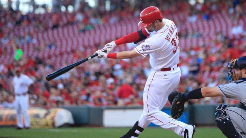 The Reds’ Jesse Winker singles against the Padres on Tuesday, Aug. 8, 2017, at Great American Ball Park in Cincinnati. David Jablonski/Staff