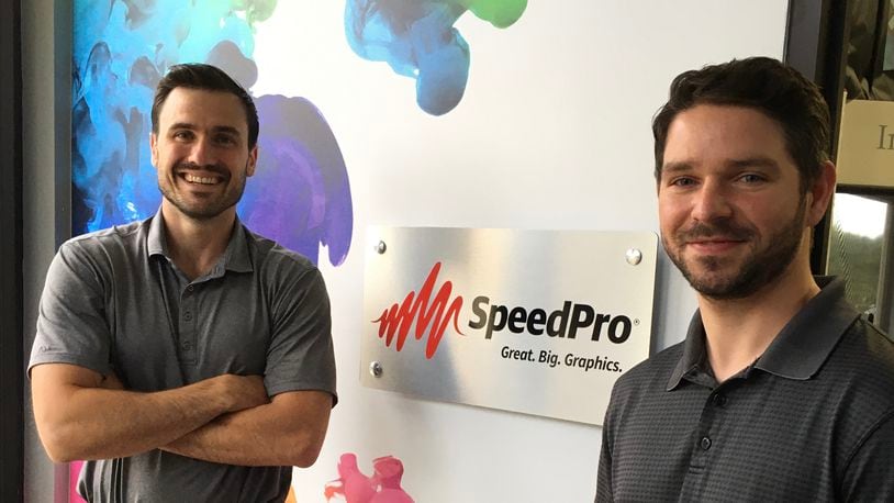 Sean Hohenstein, left, and Cody Scarberry, right, own SpeedPro Dayton.
