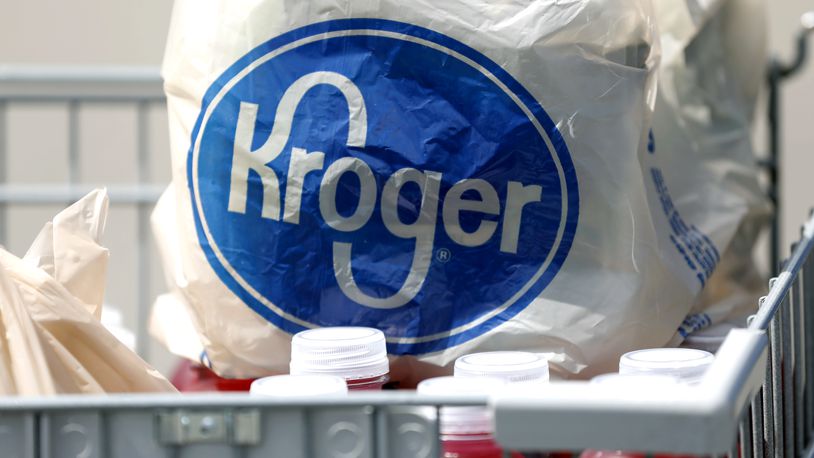 FILE- In this June 15, 2017, file photo, bagged purchases from a Kroger grocery store sit in a shopping cart in Flowood, Miss. Kroger Co. will close two supermarkets in Southern California in response to a local ordinance requiring extra pay for certain grocery employees working during the coronavirus pandemic. The decision announced by the company Monday, Feb. 1, 2021, follows a unanimous vote last month by the Long Beach City Council mandating a 120-day increase of $4 an hour for employees of supermarkets with at least 300 employees nationwide and more than 15 in Long Beach. (AP Photo/Rogelio V. Solis, File)