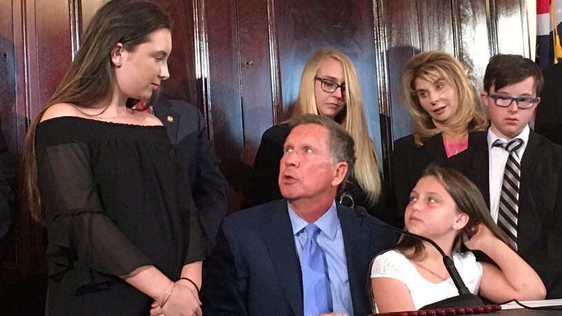Ohio Gov. John Kasich signed Judy’s Law, which provides harsher penalties for attackers who disfigure or maim their victims. Judy Malinowski’s daughters, Kaylyn, 13, and Madison, 10, attended the signing ceremony.