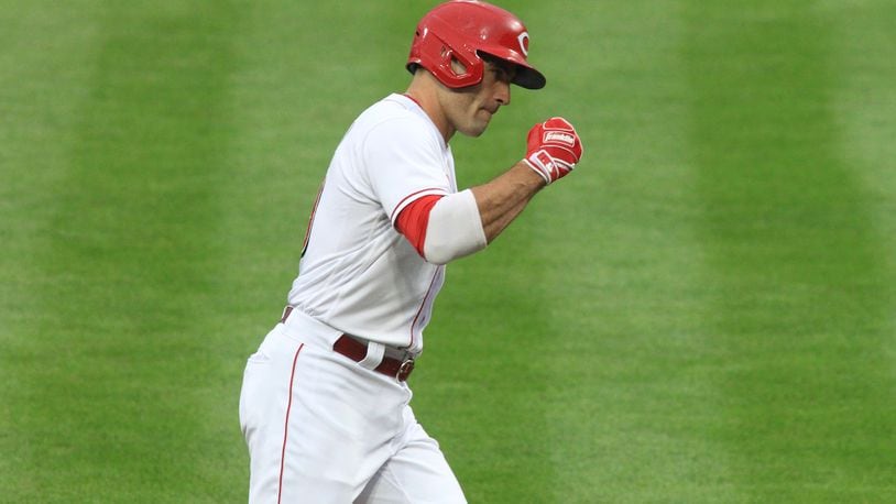 Joey Votto, of the Reds, celebrates after hitting a two-run home run against the Brewers on Wednesday, Sept. 23, 2020, at Great American Ball Park in Cincinnati. David Jablonski/Staff
