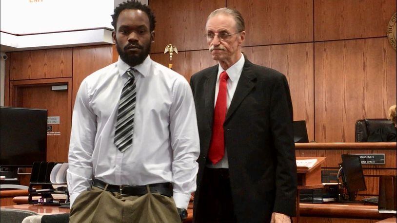 Anthony Austin (left) and attorney Carl Goraleski enter a not guilty plea Monday to a charge of control of dogs, a first-degree misdemeanor punishable by up to six months in jail and a $1,000 fine. Prosecutors allege Austin’s dog mauled Maurice Brown to death in April 2017. STAFF/MARK GOKAVI