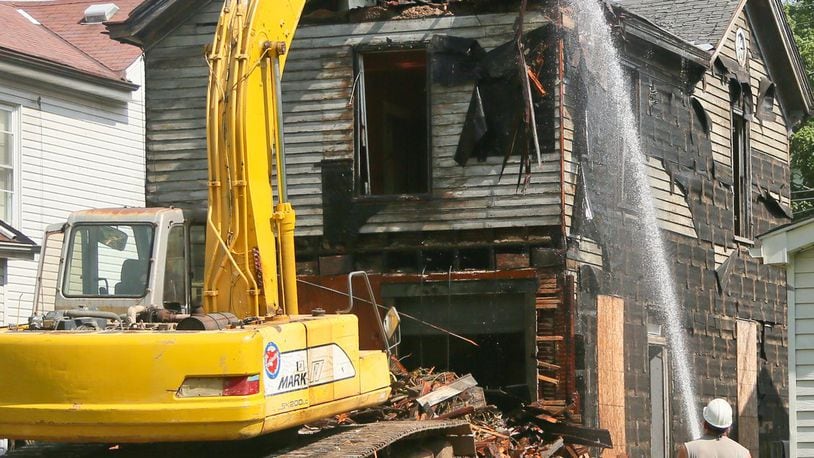Demolition crews tear down a house in 2016. GREG LYNCH / STAFF