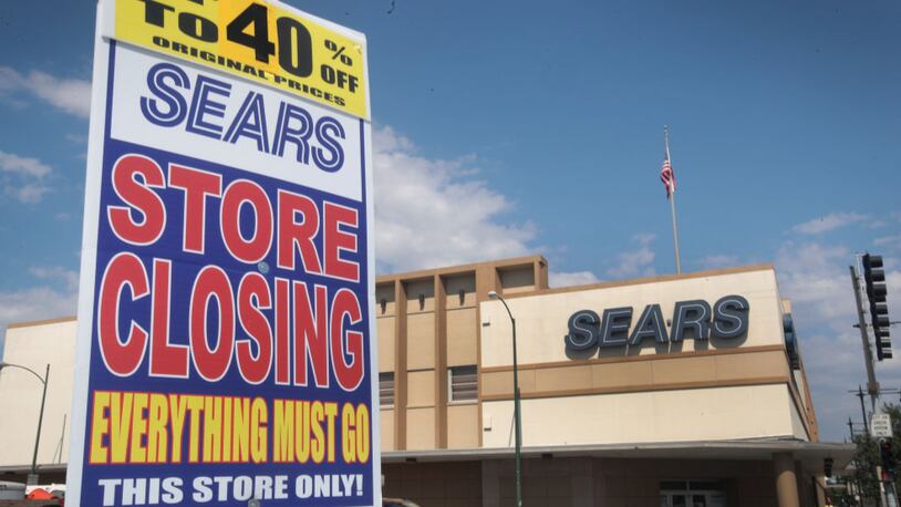 CHICAGO, IL - JULY 07:  A worker holds a sign announcing a store-closing sale outside the 60-year-old Sears store in the Galewood neighborhood on July 7, 2017 in Chicago, Illinois.  When the store closes, only one Sears store will remain in Chicago, the home of the company's first store and former headquarters of the retail giant. Today Sears Holdings, the parent company of Sears and Kmart announced it would be closing another 43 stores beyond those previously scheduled for closing.  The closings will bring Sears' store count to nearly half of what it was five years ago.  (Photo by Scott Olson/Getty Images)
