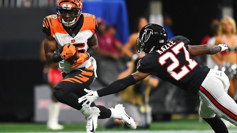 ATLANTA, GA - SEPTEMBER 30: John Ross #15 of the Cincinnati Bengals breaks a tackle by Damontae Kazee #27 of the Atlanta Falcons en route to a touchdown during the second quarter at Mercedes-Benz Stadium on September 30, 2018 in Atlanta, Georgia. (Photo by Scott Cunningham/Getty Images)