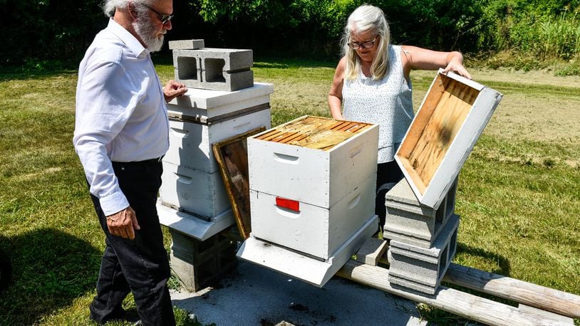 Beekeepers Yvonne Campbell Johnson (right) and Johnny Mack Brown with EZ Honey in Fairfield. NICK GRAHAM/STAFF