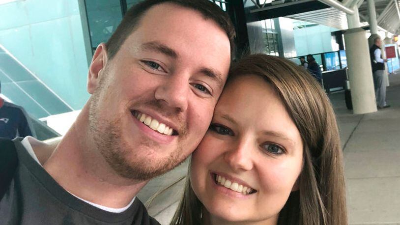 In this selfie provided by Clark and Heather Ensminger, Clark Ensminger, left, poses with his wife Heather in Nashville, Tenn., marking the cross-country trip they are taking to see every U.S. Disney park in a single day.