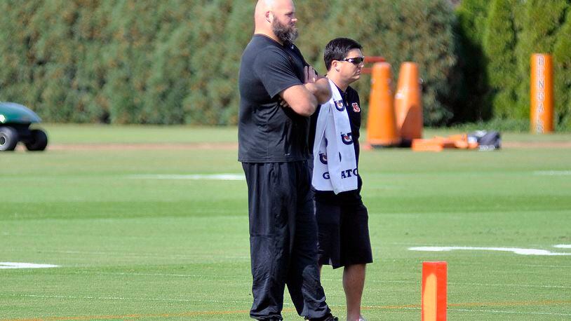 Cincinnati Bengals left tackle Andrew Withworth watches practice Wednesday along side director of rehabilitation Nick Cosgray. JAY MORRISON/STAFF