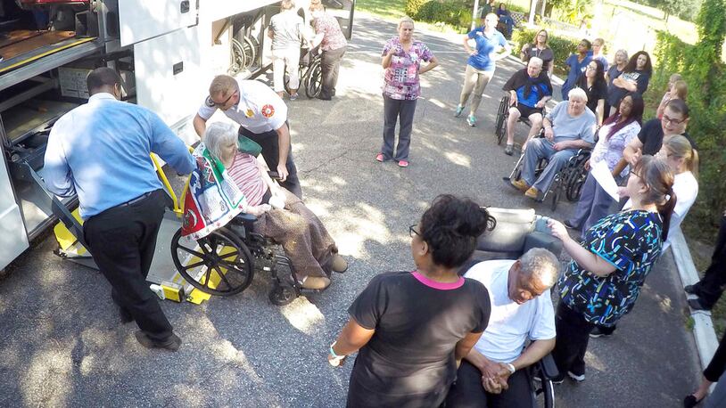 Staff members at Westwood Nursing and Rehabilitation Center in Fort Walton Beach, Fla., and firefighters from Fort Walton Beach Fire Department load Hurricane Irma evacuees, who had stayed at Westwood since last Saturday, onto a bus on Wednesday Sept. 13, 2017 to head back to the their facility in Mayo, Fla. (Nick Tomecek/Northwest Florida Daily News via AP)