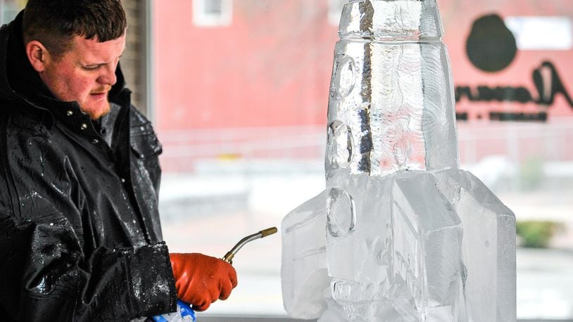 Jonathon Michael, lead carver with Artic Diamond Ice Sculptures, created a sculpture of a rocket during a media preview event for IceFest 2017 in Hamilton. NICK GRAHAM/STAFF